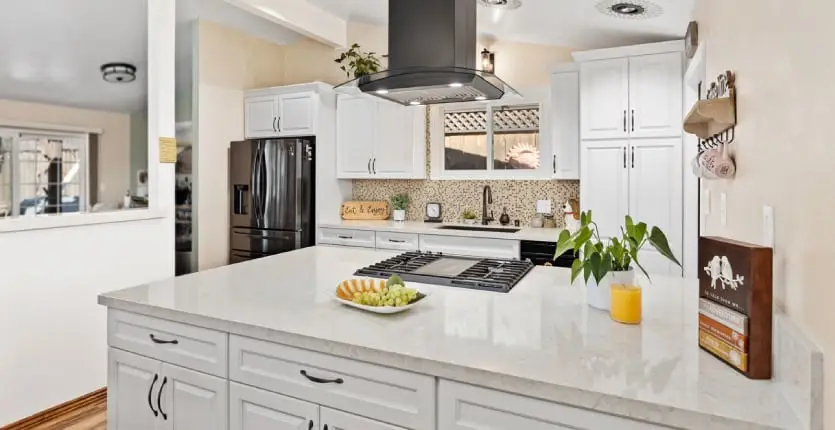 Kitchen with white painted raised panel door cabinets and oil-rubbed bronze fixtures.